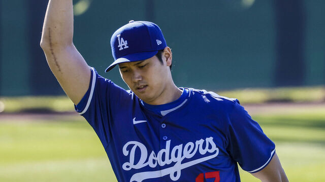 Goodyear, Arizona, Wednesday, February 14, 2024 - Bearing the scar of Tommy John surgery, Shohei Ohtani stretches at the LA Dodgers first official day of spring training. (Robert Gauthier/Los Angeles Times via Getty Images)