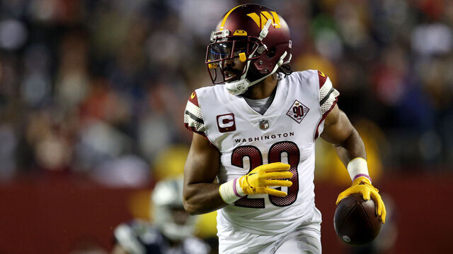 LANDOVER, MARYLAND - JANUARY 08: Cornerback Kendall Fuller #29 of the Washington Commanders celebrates while returning an interception for a touchdown against the Dallas Cowboys at FedExField on January 08, 2023 in Landover, Maryland.