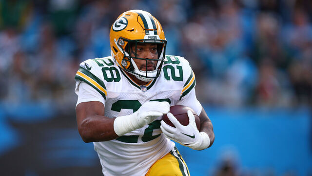 CHARLOTTE, NORTH CAROLINA - DECEMBER 24: AJ Dillon #28 of the Green Bay Packers carries the ball during the second half of the game against the Carolina Panthers at Bank of America Stadium on December 24, 2023 in Charlotte, North Carolina.