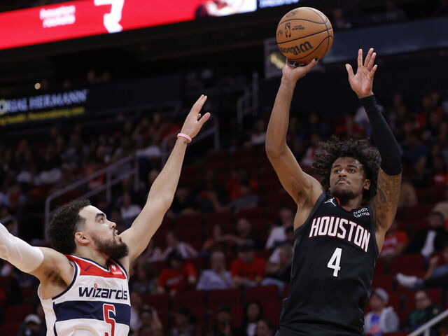HOUSTON, TEXAS - MARCH 14: Jalen Green #4 of the Houston Rockets shoots over Tyus Jones #5 of the Washington Wizards during the second half at Toyota Center on March 14, 2024 in Houston, Texas.