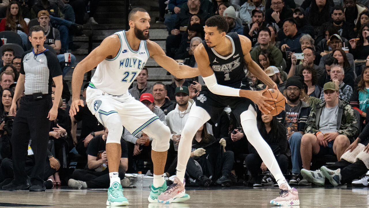 TOPSHOT - Minnesota Timberwolves' French center #27 Rudy Gobert guards San Antonio Spurs' French forward #01 Victor Wembanyama during the NBA game between the San Antonio Spurs and the Minnesota Timberwolves at the Frost Bank Center in San Antonio, Texas, on January 27, 2024.