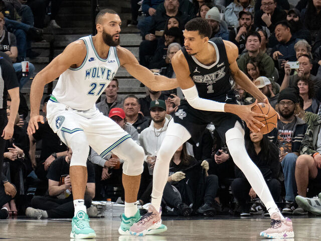 TOPSHOT - Minnesota Timberwolves' French center #27 Rudy Gobert guards San Antonio Spurs' French forward #01 Victor Wembanyama during the NBA game between the San Antonio Spurs and the Minnesota Timberwolves at the Frost Bank Center in San Antonio, Texas, on January 27, 2024.