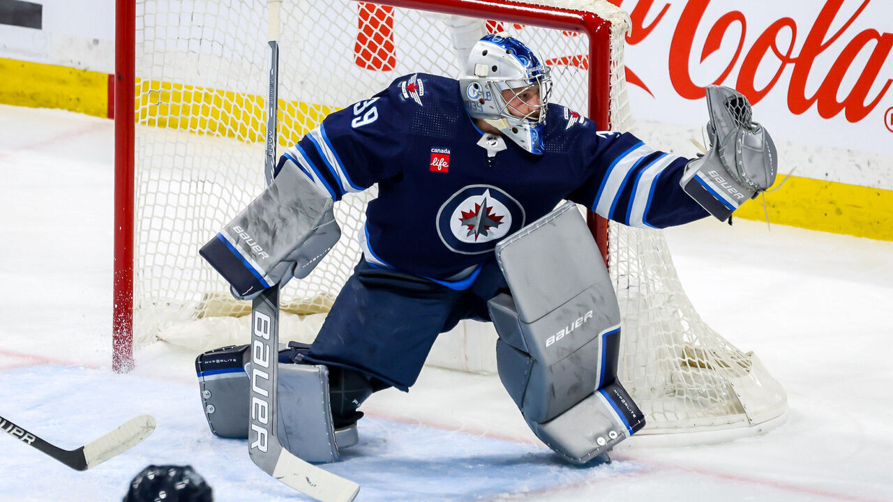 WINNIPEG, CANADA - MARCH 15: Goaltender Laurent Brossoit #39 of the Winnipeg Jets makes a glove save during first period action against the Anaheim Ducks at the Canada Life Centre on March 15, 2024 in Winnipeg, Manitoba, Canada.