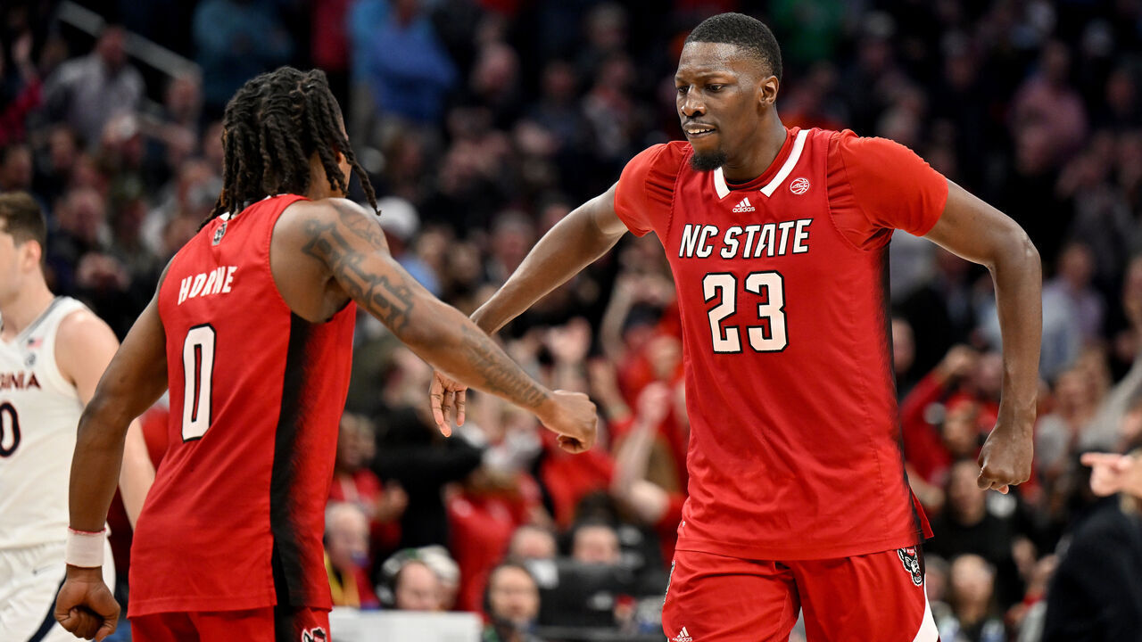 WASHINGTON, DC - MARCH 15: DJ Horne #0 of the North Carolina State Wolfpack celebrates with Mohamed Diarra #23 in overtime against the Virginia Cavaliers in the Semifinals of the ACC Men's Basketball Tournament at Capital One Arena on March 15, 2024 in Washington, DC.