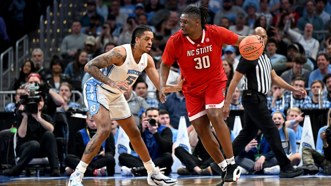 WASHINGTON, DC - MARCH 16: DJ Burns Jr. #30 of the North Carolina State Wolfpack handles the ball in the first half against Armando Bacot #5 of the North Carolina Tar Heels in the Championship Game of the ACC Men's Basketball Tournament at Capital One Arena on March 16, 2024 in Washington, DC.