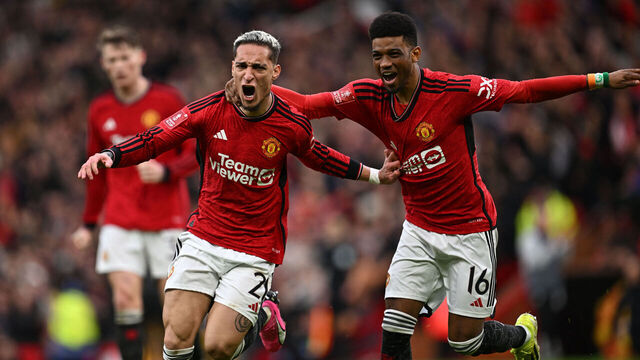 Manchester United's Brazilian midfielder #21 Antony (L) celebrates with Manchester United's Ivorian midfielder #16 Amad Diallo (R) after scoring their second goal during the English FA Cup Quarter Final football match between Manchester United and Liverpool at Old Trafford in Manchester, north west England, on March 17, 2024.