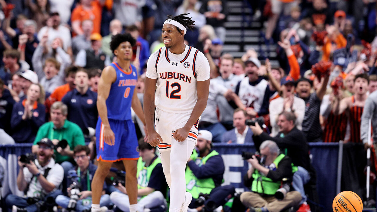 NASHVILLE, TENNESSEE - MARCH 17: Denver Jones #12 of the Auburn Tigers celebrates a basket against the Florida Gators during the second half of the SEC Tournament Championship game at Bridgestone Arena on March 17, 2024 in Nashville, Tennessee.