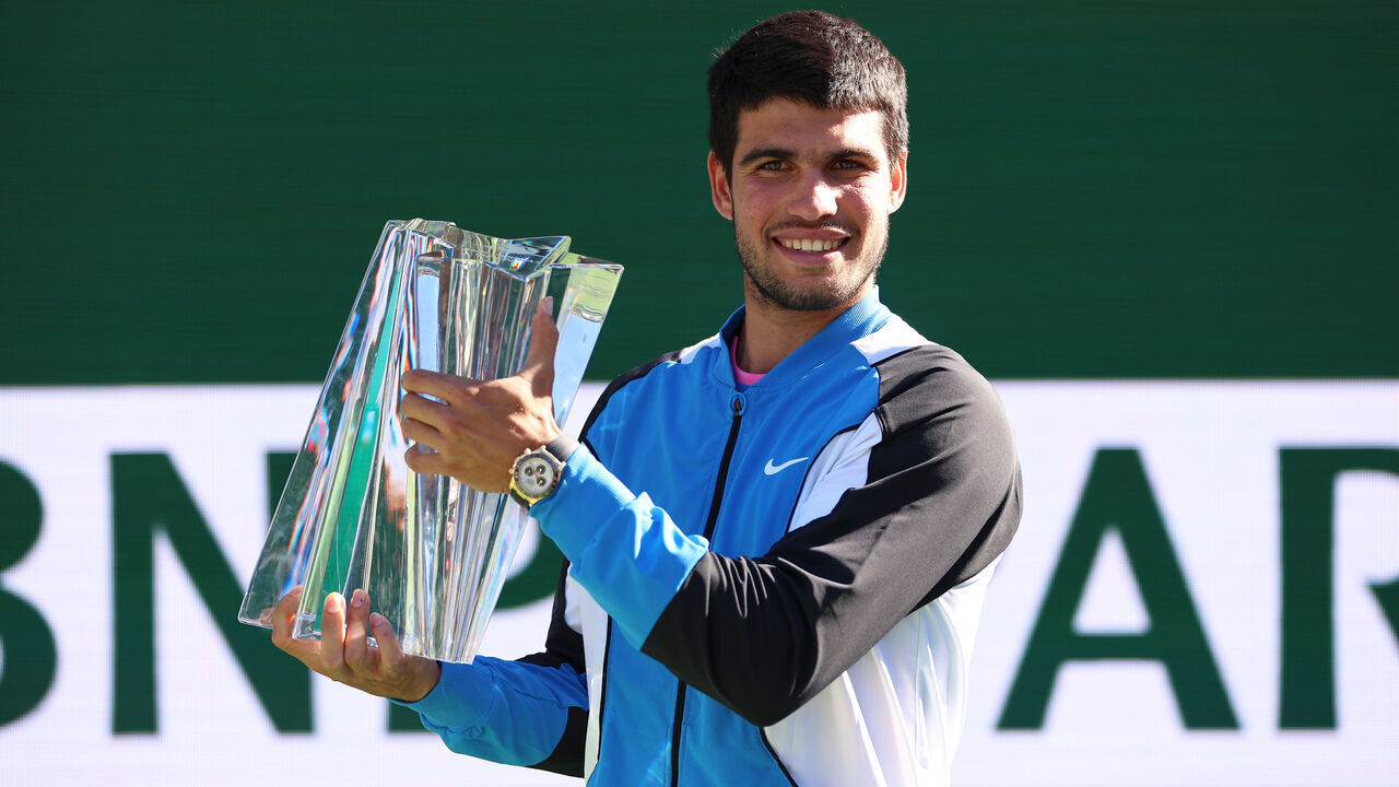 INDIAN WELLS, CALIFORNIA - MARCH 17: Carlos Alcaraz of Spain holds his winners trophy after his straight sets victory against Daniil Medvedev in the Men's Final during the BNP Paribas Open at Indian Wells Tennis Garden on March 17, 2024 in Indian Wells, California.