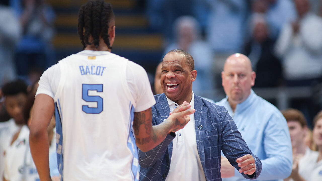 CHAPEL HILL, NC - MARCH 05: North Carolina Tar Heels head coach Hubert Davis welcomes North Carolina Tar Heels forward Armando Bacot (5) to the home bench for the final time in the regular season during the college basketball game between the North Carolina Tar Heels and the Notre Dame Fighting Irish on March 5, 2024 at the Dean Smith Center in Chapel Hill, NC.
