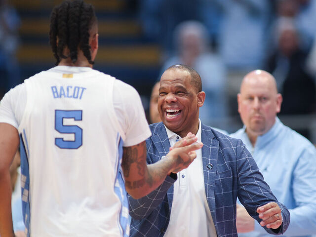 CHAPEL HILL, NC - MARCH 05: North Carolina Tar Heels head coach Hubert Davis welcomes North Carolina Tar Heels forward Armando Bacot (5) to the home bench for the final time in the regular season during the college basketball game between the North Carolina Tar Heels and the Notre Dame Fighting Irish on March 5, 2024 at the Dean Smith Center in Chapel Hill, NC.