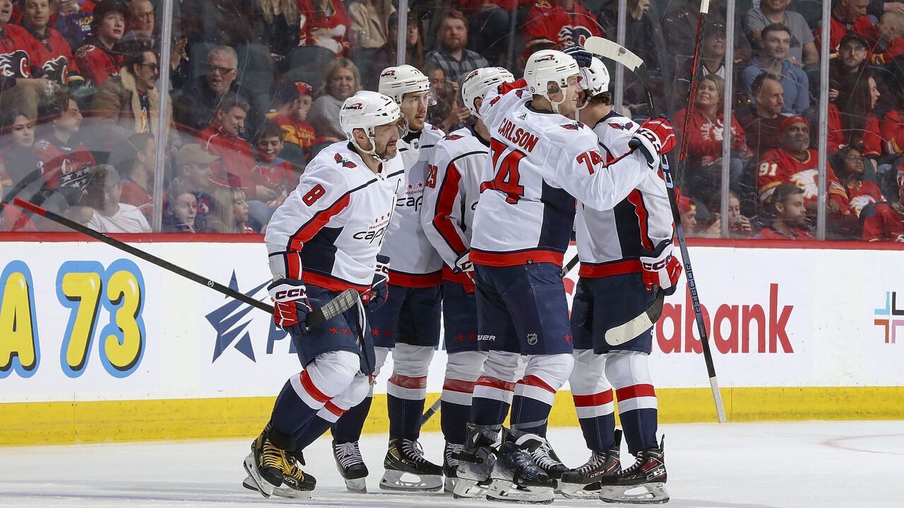 CALGARY, AB - MARCH 18: Alex Ovechkin #8 and John Carlson #74 of the Washington Capitals celebrates with teammates after a goal against the Calgary Flames at Scotiabank Saddledome on March 18, 2024 in Calgary, Alberta, Canada.