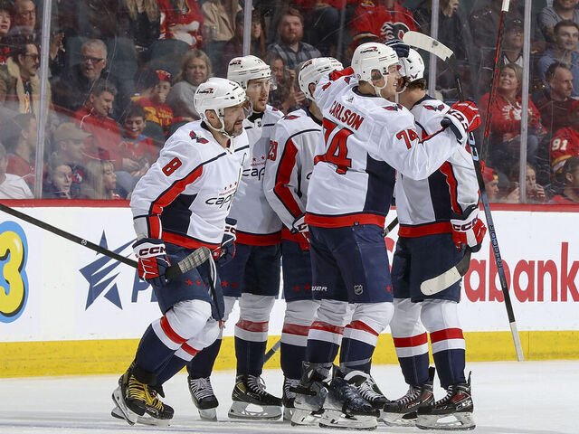 CALGARY, AB - MARCH 18: Alex Ovechkin #8 and John Carlson #74 of the Washington Capitals celebrates with teammates after a goal against the Calgary Flames at Scotiabank Saddledome on March 18, 2024 in Calgary, Alberta, Canada.