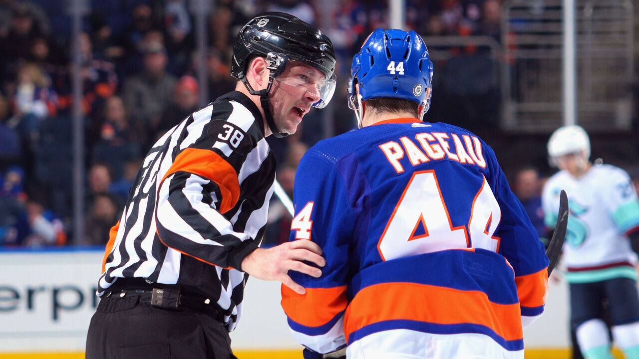 ELMONT, NEW YORK - FEBRUARY 13: Referee Peter MacDougall #38 checks Jean-Gabriel Pageau #44 of the New York Islanders after he took a high stick from Andre Burakovsky #95 of the Seattle Kraken during the first period UBS Arena on February 13, 2024 in Elmont, New York.