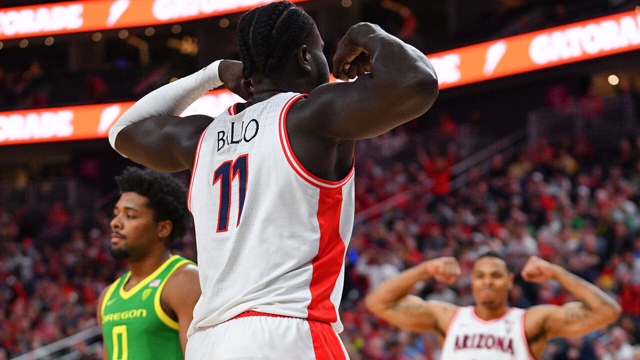 LAS VEGAS, NV - MARCH 15: Arizona Wildcats center Oumar Ballo (11) and Arizona Wildcats forward Keshad Johnson (16) flex after a basket during the semifinal game of the men's Pac-12 Tournament between the Oregon Ducks and the Arizona Wildcats on March 15, 2024, at the T-Mobile Arena in Las Vegas, NV.
