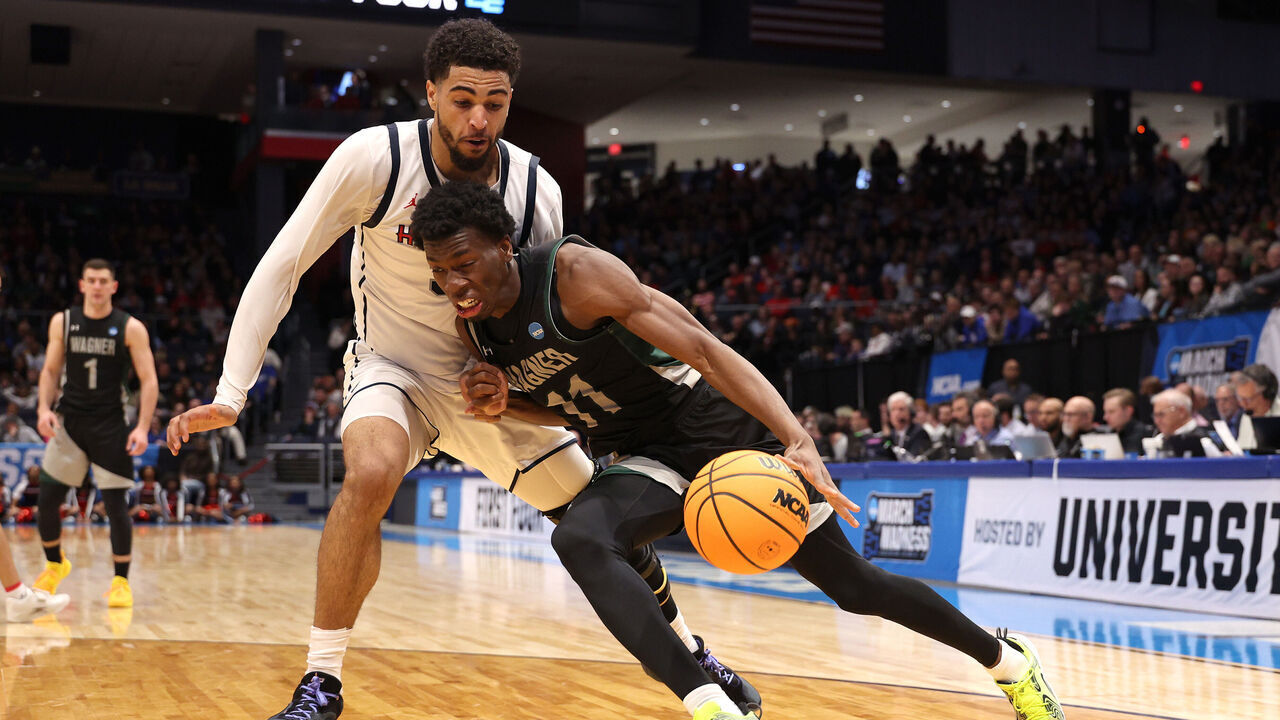 DAYTON, OHIO - MARCH 19: Melvin Council Jr. #11 of the Wagner Seahawks drives against Seth Towns #31 of the Howard Bison during the second half in the First Four game during the NCAA Men's Basketball Tournament at University of Dayton Arena on March 19, 2024 in Dayton, Ohio.