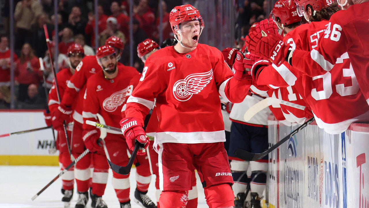 DETROIT, MICHIGAN - MARCH 19: Lucas Raymond #23 of the Detroit Red Wings celebrates his late third period goal with teammates while playing the Columbus Blue Jackets at Little Caesars Arena on March 19, 2024 in Detroit, Michigan.