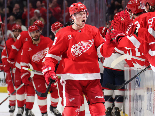 DETROIT, MICHIGAN - MARCH 19: Lucas Raymond #23 of the Detroit Red Wings celebrates his late third period goal with teammates while playing the Columbus Blue Jackets at Little Caesars Arena on March 19, 2024 in Detroit, Michigan.