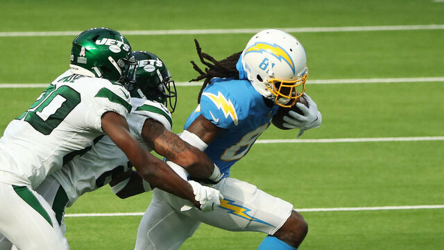 INGLEWOOD, CALIFORNIA - NOVEMBER 22: Mike Williams #81 of the Los Angeles Chargers breaks away from a tackle from Arthur Maulet #23 and Marcus Maye #20 of the New York Jets during the second quarter at SoFi Stadium on November 22, 2020 in Inglewood, California.