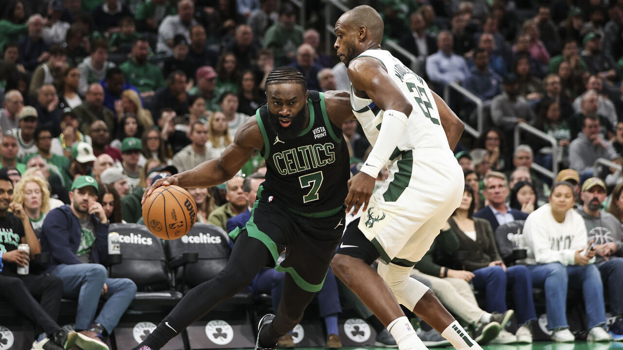 BOSTON, MA - MARCH 20: Jaylen Brown #7 of the Boston Celtics drives to the basket against Khris Middleton #22 of the Milwaukee Bucks in the fourth quarter at TD Garden on March 20, 2024 in Boston, Massachusetts.
