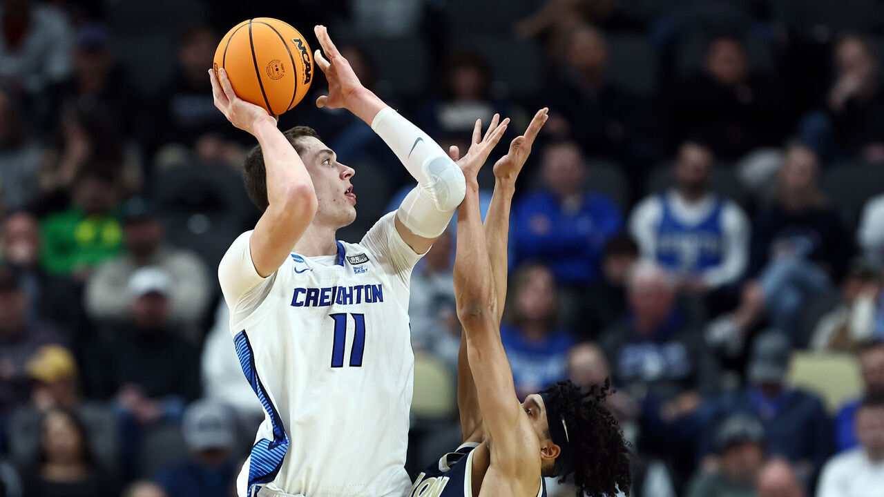 PITTSBURGH, PENNSYLVANIA - MARCH 21: Ryan Kalkbrenner #11 of the Creighton Bluejays takes a shot over Enrique Freeman #25 of the Akron Zips in the second half in the first round of the NCAA Men's Basketball Tournament at PPG PAINTS Arena on March 21, 2024 in Pittsburgh, Pennsylvania. The Creighton Bluejays defeated the Akron Zips 77-60.