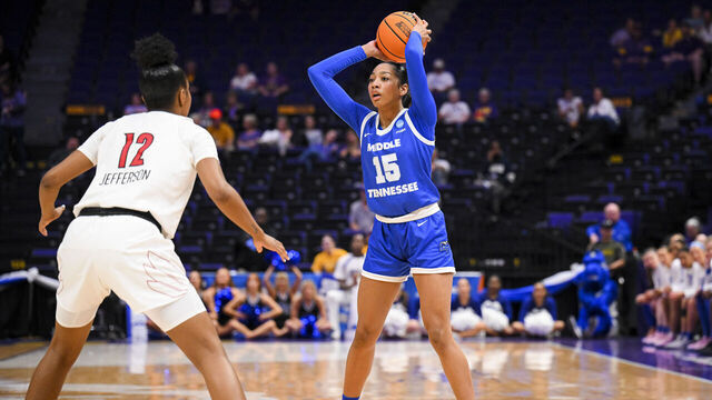 BATON ROUGE, LOUISIANA - MARCH 22: Ta'Mia Scott of the Middle Tennessee Blue Raiders looks for a pass against Kiki Jefferson of the Louisville Cardinals during the first round of the 2024 NCAA Women's Basketball Tournament held at Pete Maravich Assembly Center on March 22, 2024 in Baton Rouge, Louisiana.
