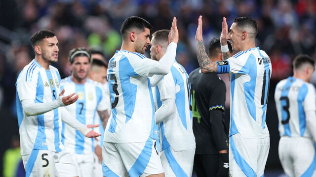 Argentina's defender #13 Cristian Romero (C) celebrates socring a goal with Argentina's forward #11 Angel Di Maria (R) during the international friendly football match between El Salvador and Argentina at Lincoln Financial Field in Philadelphia, Pennsylvania, on March 22, 2024.
