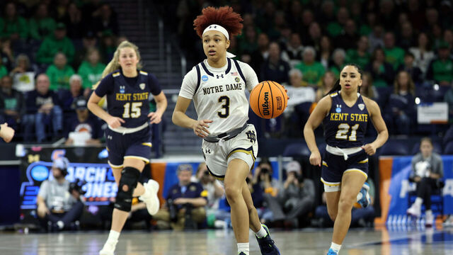 SOUTH BEND, INDIANA - MARCH 23: Hannah Hidalgo #3 of the Notre Dame Fighting Irish dribbles the ball down the court in front of Bridget Dunn #15 of the Kent State Golden Flashes and Dionna Gray #21 during the first round of the 2024 NCAA Women's Basketball Tournament held at Purcell Pavilion on March 23, 2024 in South Bend, Indiana.