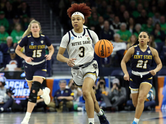 SOUTH BEND, INDIANA - MARCH 23: Hannah Hidalgo #3 of the Notre Dame Fighting Irish dribbles the ball down the court in front of Bridget Dunn #15 of the Kent State Golden Flashes and Dionna Gray #21 during the first round of the 2024 NCAA Women's Basketball Tournament held at Purcell Pavilion on March 23, 2024 in South Bend, Indiana.