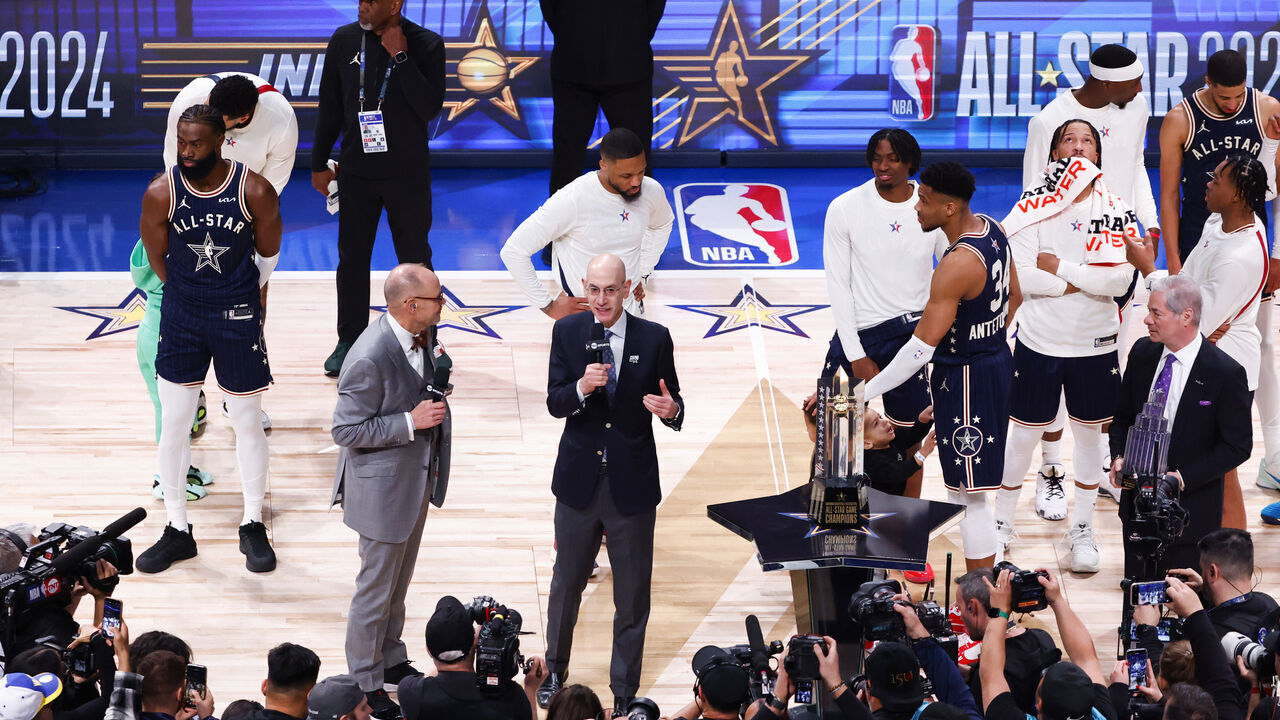 INDIANAPOLIS, INDIANA - FEBRUARY 18: Ernie Johnson Jr. and NBA Commissioner Adam Silver speak on the court during the 2024 NBA All-Star Game at Gainbridge Fieldhouse on February 18, 2024 in Indianapolis, Indiana.
