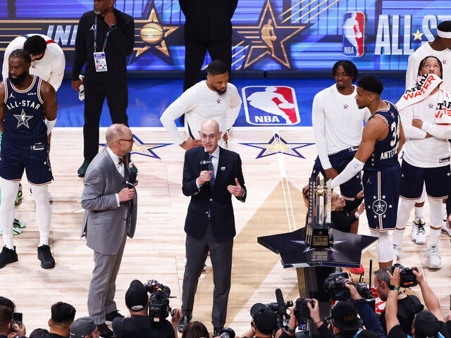 INDIANAPOLIS, INDIANA - FEBRUARY 18: Ernie Johnson Jr. and NBA Commissioner Adam Silver speak on the court during the 2024 NBA All-Star Game at Gainbridge Fieldhouse on February 18, 2024 in Indianapolis, Indiana.