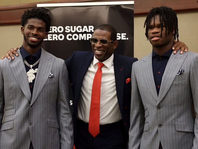 BIRMINGHAM, AL - JULY 21: Jackson State Tigers quarterback Shedeur Sanders, Jackson State Tigers head coach Deion Sanders and Jackson State Tigers wide receiver Travis Hunter pose for photos during the 2022 SWAC Football Media Day on July 21, 2022 at the Birmingham Sheraton Hotel in Birmingham, Alabama.