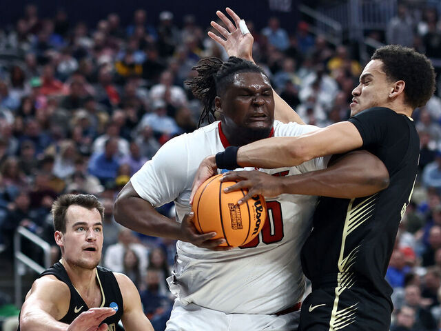 PITTSBURGH, PENNSYLVANIA - MARCH 23: DJ Burns Jr. #30 of the North Carolina State Wolfpack battles for a loose ball against Chris Conway #2 and Jack Gohlke #3 of the Oakland Golden Grizzlies during the second half of a game in the second round of the NCAA Men's Basketball Tournament at PPG PAINTS Arena on March 23, 2024 in Pittsburgh, Pennsylvania.