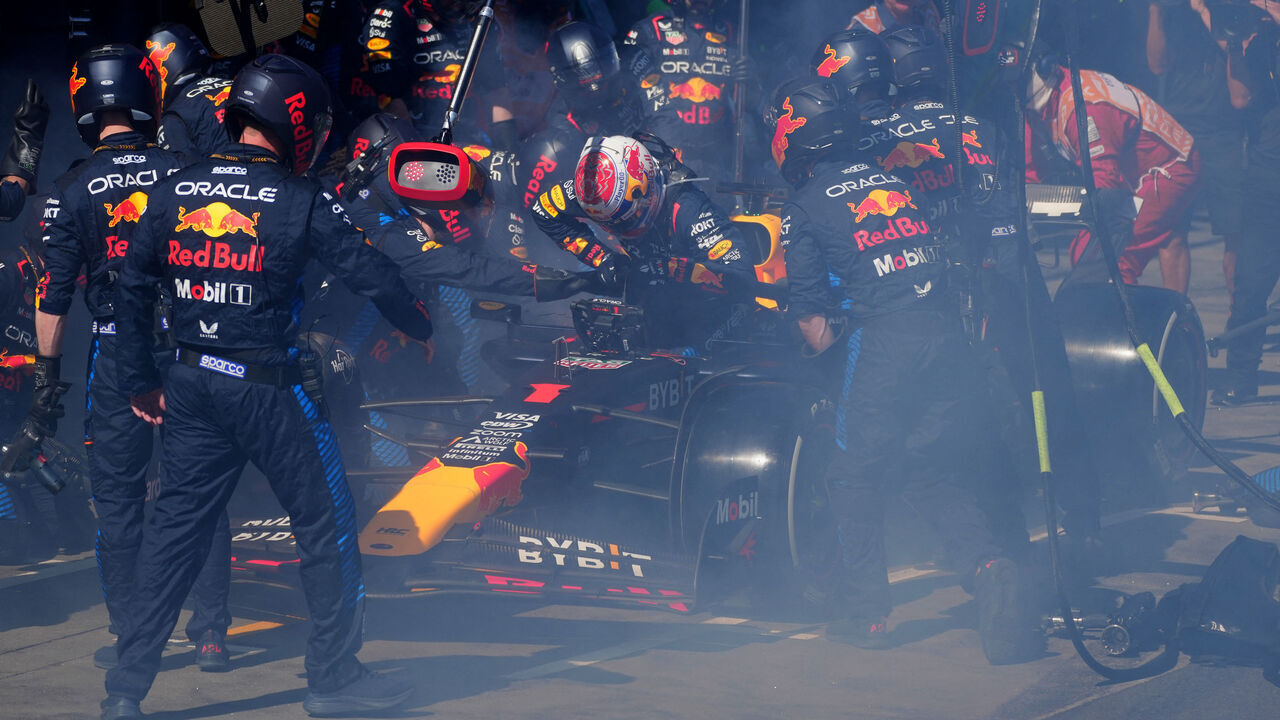 Red Bull Racing's Dutch driver Max Verstappen (C) comes out after smoke billowing from his car during the Australian Formula One Grand Prix at Albert Park Circuit in Melbourne on March 24, 2024.