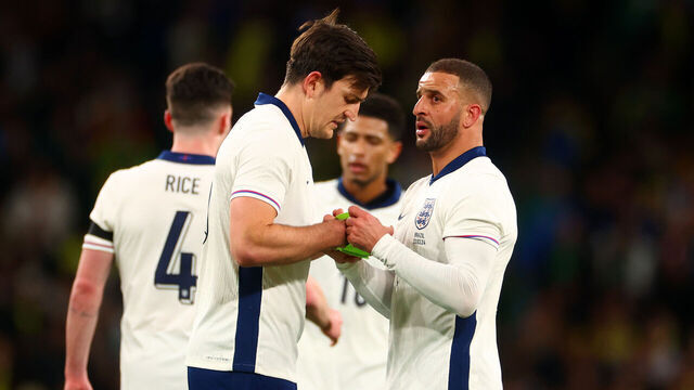 LONDON, ENGLAND - MARCH 23: Kyle Walker of England gives the captain's armband to team-mate Harry Maguire before leaving the field through injury during the international friendly match between England and Brazil at Wembley Stadium on March 23, 2024 in London, England.