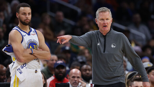 WASHINGTON, DC - FEBRUARY 27: Head coach Steve Kerr of the Golden State Warriors (R) and Stephen Curry #30 of the Golden State Warriors look on against the Washington Wizards during the first half at Capital One Arena on February 27, 2024 in Washington, DC.