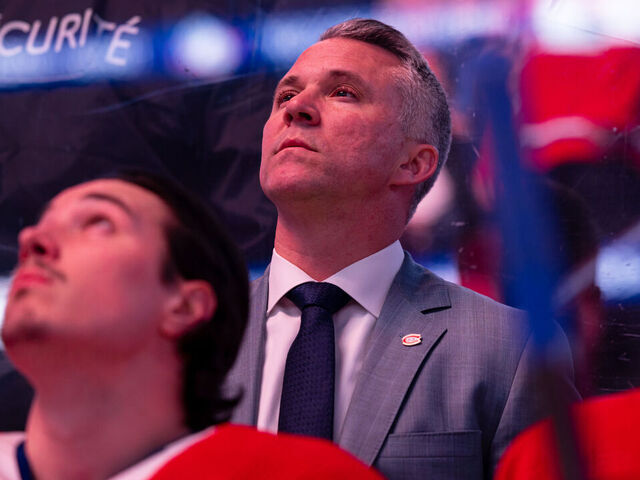 MONTREAL, CANADA - MARCH 14: Montreal Canadiens Head Coach Martin St-Louis looks on from behind the bench before the national anthem of the NHL regular season game between the Montreal Canadiens and the Boston Bruins at the Bell Centre on March 14, 2024 in Montreal, Quebec, Canada. The Boston Bruins defeated the Montreal Canadiens by a score of 2-1 in overtime.