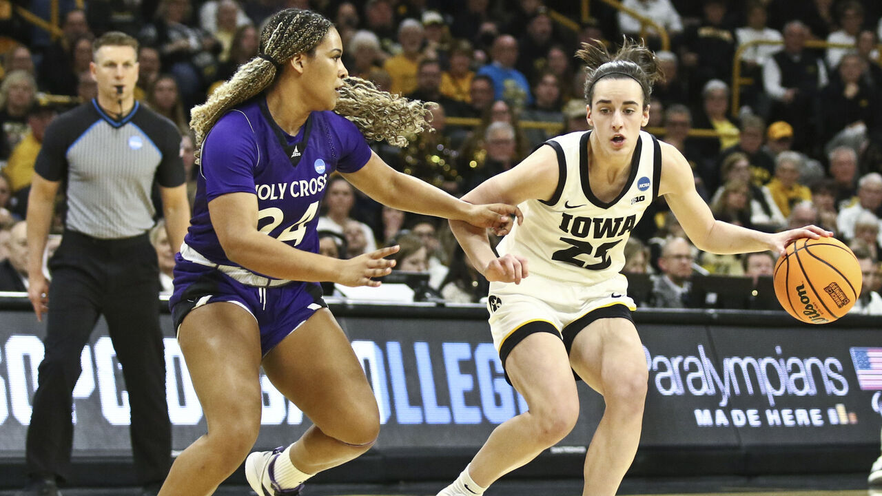 IOWA CITY, IOWA- MARCH 23: Guard Caitlin Clark #22 of the Iowa Hawkeyes goes to the basket during the first half against guard Simone Foreman #24 of the Holy Cross Crusaders during their match-up in the 2024 NCAA Division 1 Womens Basketball Championship at Carver-Hawkeye Arena on March 23, 2024 in Iowa City, Iowa.