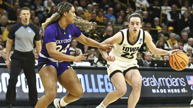 IOWA CITY, IOWA- MARCH 23: Guard Caitlin Clark #22 of the Iowa Hawkeyes goes to the basket during the first half against guard Simone Foreman #24 of the Holy Cross Crusaders during their match-up in the 2024 NCAA Division 1 Womens Basketball Championship at Carver-Hawkeye Arena on March 23, 2024 in Iowa City, Iowa.