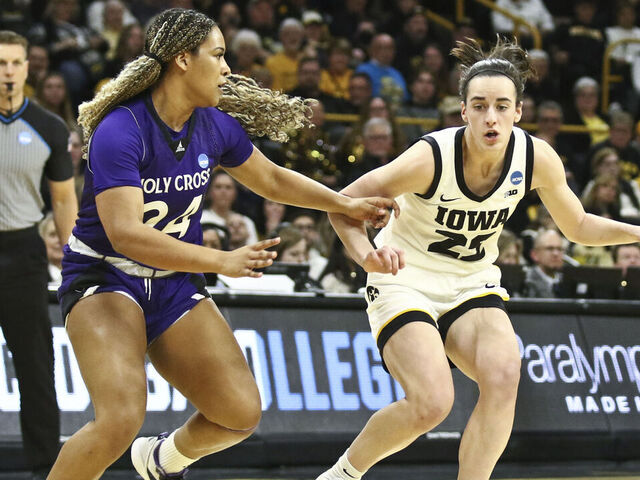 IOWA CITY, IOWA- MARCH 23: Guard Caitlin Clark #22 of the Iowa Hawkeyes goes to the basket during the first half against guard Simone Foreman #24 of the Holy Cross Crusaders during their match-up in the 2024 NCAA Division 1 Womens Basketball Championship at Carver-Hawkeye Arena on March 23, 2024 in Iowa City, Iowa.