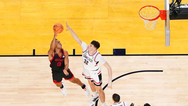 HOUSTON, TEXAS - APRIL 03: (EDITOR'S NOTE: This image was captured using a remote camera.) Jaedon LeDee #13 of the San Diego State Aztecs shoots the ball against Donovan Clingan #32 of the Connecticut Huskies during the second half in the NCAA Men's Basketball Tournament National Championship game at NRG Stadium on April 03, 2023 in Houston, Texas.