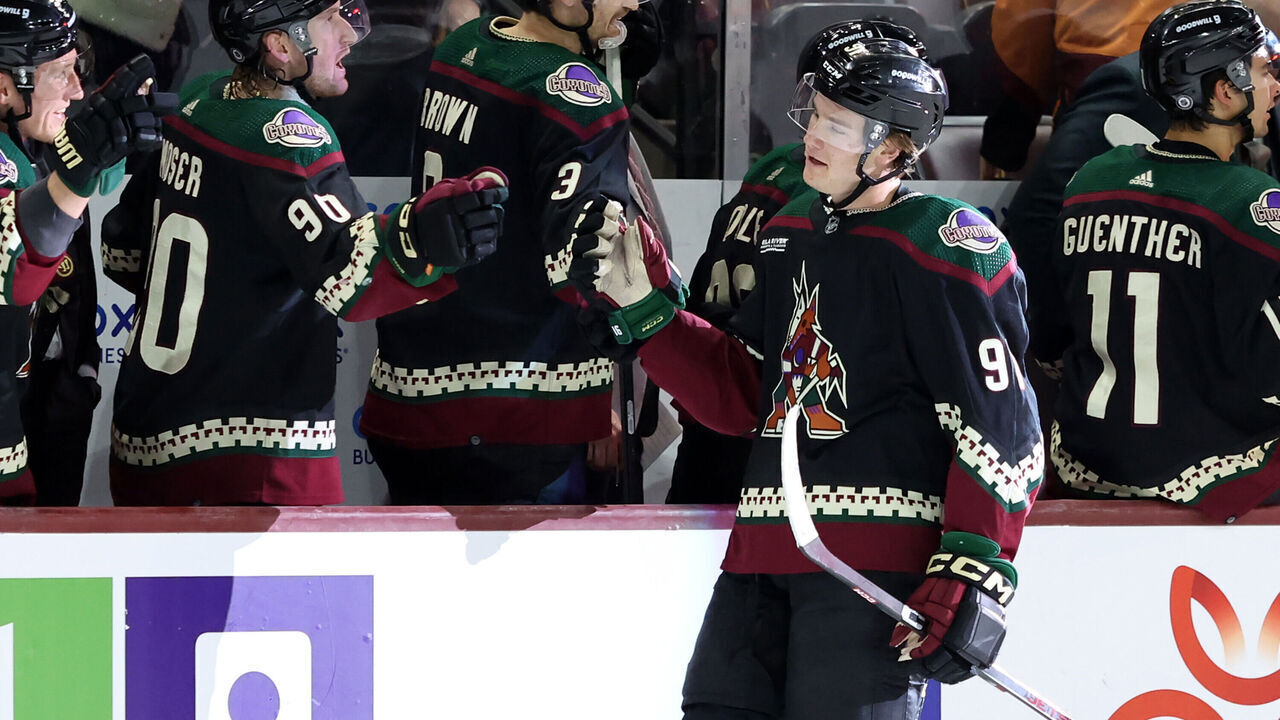 TEMPE, ARIZONA - MARCH 26: Josh Doan #91 of the Arizona Coyotes celebrates with the Arizona Coyotes bench during the third period after his second goal of the night in his NHL debut against the Columbus Blue Jackets at Mullett Arena on March 26, 2024 in Tempe, Arizona.