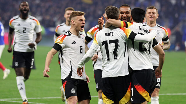 LYON, FRANCE - MARCH 23: Florian Wirtz of Germany celebrates as he scores the goal 0:1withJoshua Kimmich of Germany Ilkay Guendogan of Germany during the international friendly match between France and Germany at Groupama Stadium on March 23, 2024 in Lyon, France.