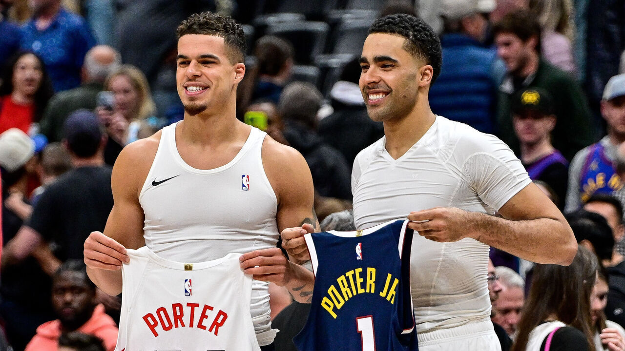 DENVER, COLORADO - MARCH 11: Michael Porter Jr. #1 of the Denver Nuggets and Jontay Porter #34 of the Toronto Raptors swap jerseys after a game at Ball Arena on March 11, 2024 in Denver, Colorado.