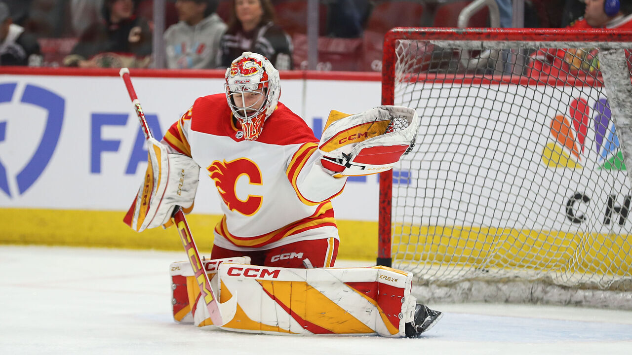 CHICAGO, IL - MARCH 26: Dustin Wolf #32 of the Calgary Flames makes a save prior to a game against the Chicago Blackhawks at the United Center on March 26, 2024 in Chicago, Illinois.