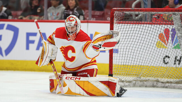 CHICAGO, IL - MARCH 26: Dustin Wolf #32 of the Calgary Flames makes a save prior to a game against the Chicago Blackhawks at the United Center on March 26, 2024 in Chicago, Illinois.
