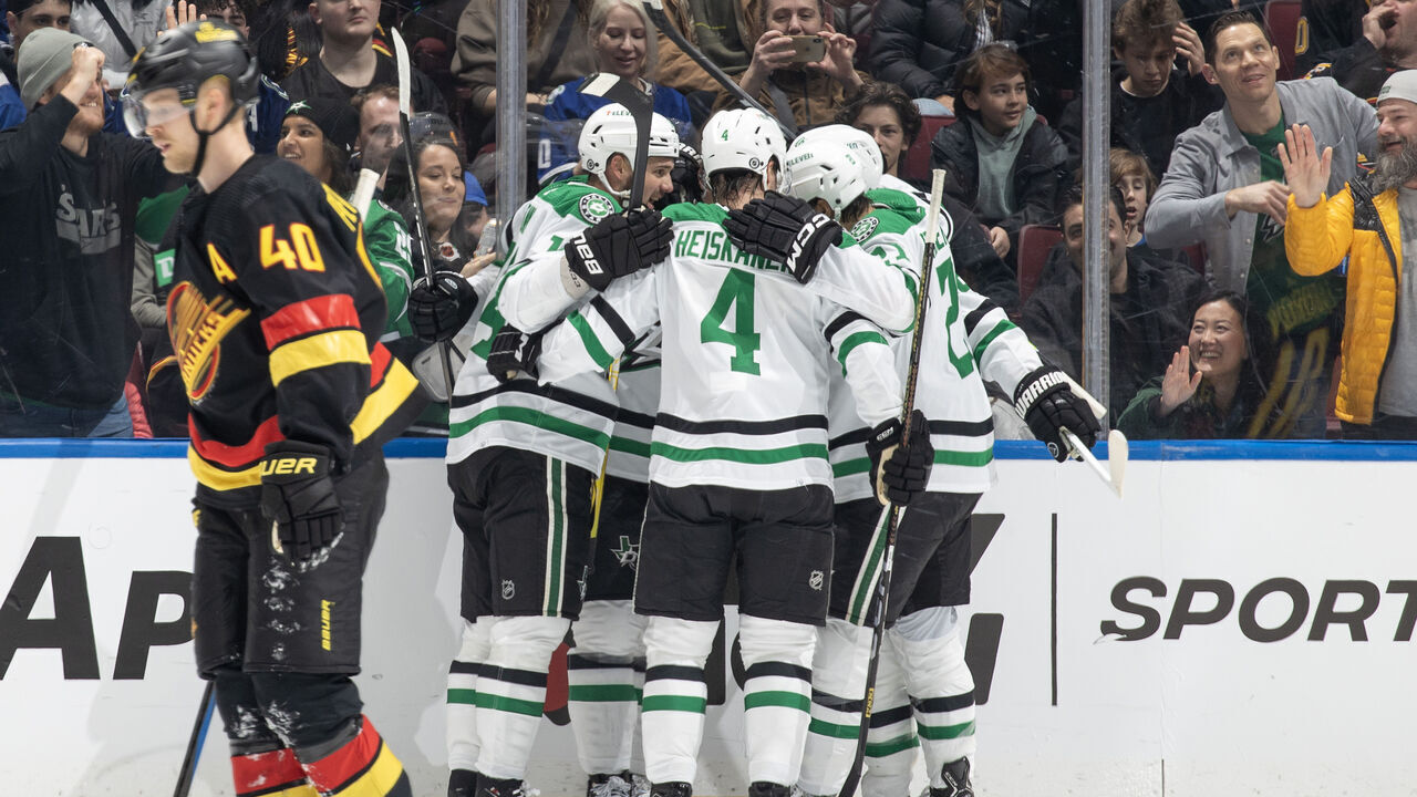 VANCOUVER, CANADA - MARCH 28: Roope Hintz #24 of the Dallas Stars celebrates his goal with teammates as Elias Pettersson #40 of the Vancouver Canucks skates on dejected during the first period of their NHL game at Rogers Arena on March 28, 2024 in Vancouver, British Columbia, Canada.
