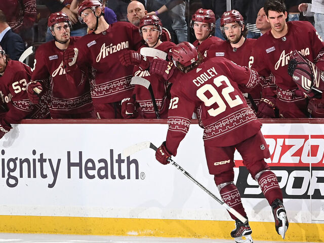 TEMPE, ARIZONA - MARCH 28: Logan Cooley #92 of the Arizona Coyotes celebrates with teammates on the bench after scoring a goal against the Nashville Predators during the first period of the game at Mullett Arena on March 28, 2024 in Tempe, Arizona.