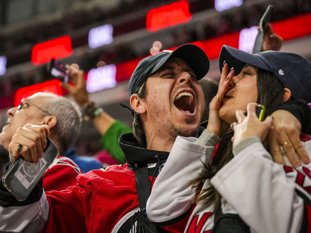 RALEIGH, NORTH CAROLINA - MARCH 07: Carolina Hurricanes fans celebrate a goal during the third period of a game against the Montréal Canadiens at PNC Arena on March 07, 2024 in Raleigh, North Carolina.