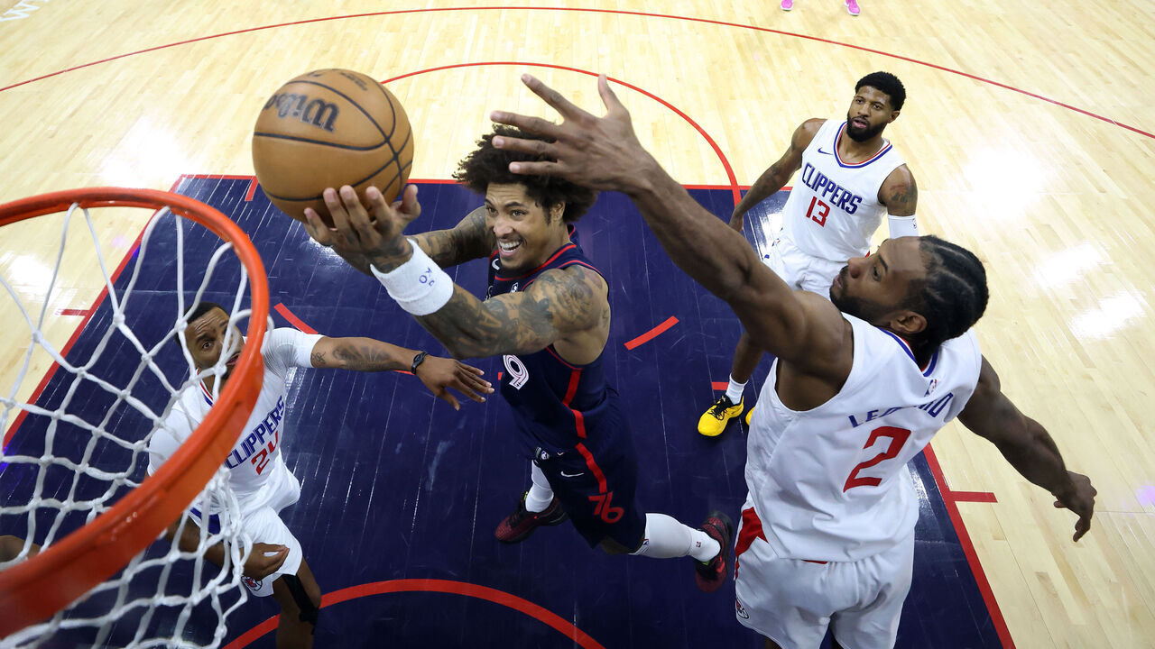 PHILADELPHIA, PENNSYLVANIA - MARCH 27: Kelly Oubre Jr. #9 of the Philadelphia 76ers shoots a lay up past Kawhi Leonard #2 of the LA Clippers during the fourth quarter at the Wells Fargo Center on March 27, 2024 in Philadelphia, Pennsylvania.