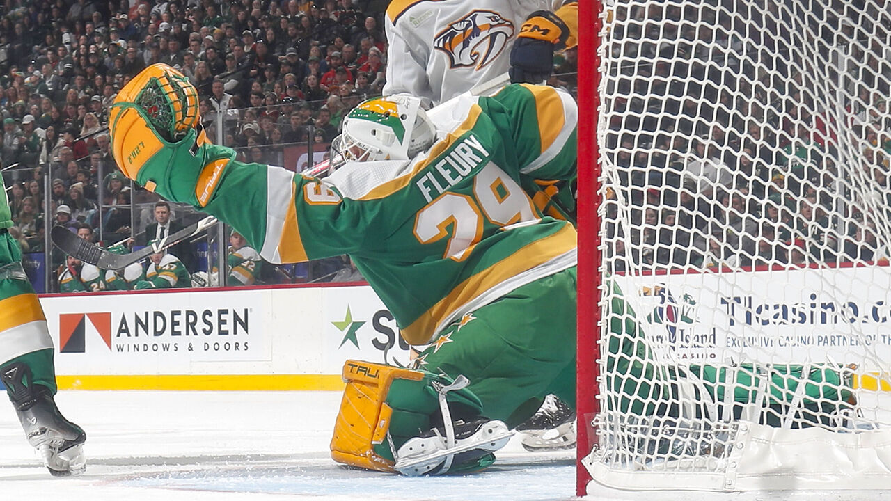 SAINT PAUL, MN - MARCH 10: Marc-Andre Fleury #29 of the Minnesota Wild makes a save with Luke Evangelista #77 of the Nashville Predators nearby during the game at the Xcel Energy Center on March 10, 2024 in Saint Paul, Minnesota.